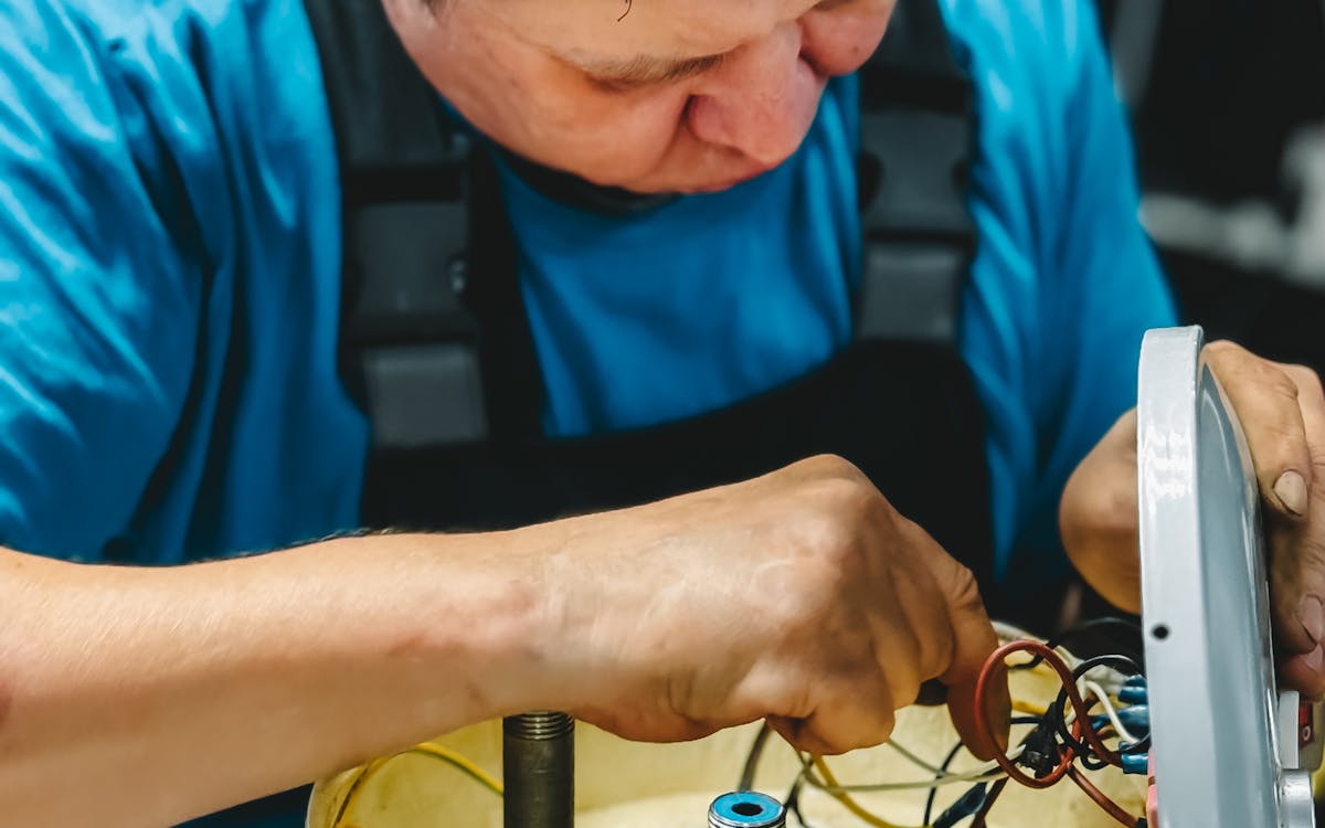 Skilled technician carrying out professional washing machine maintenance